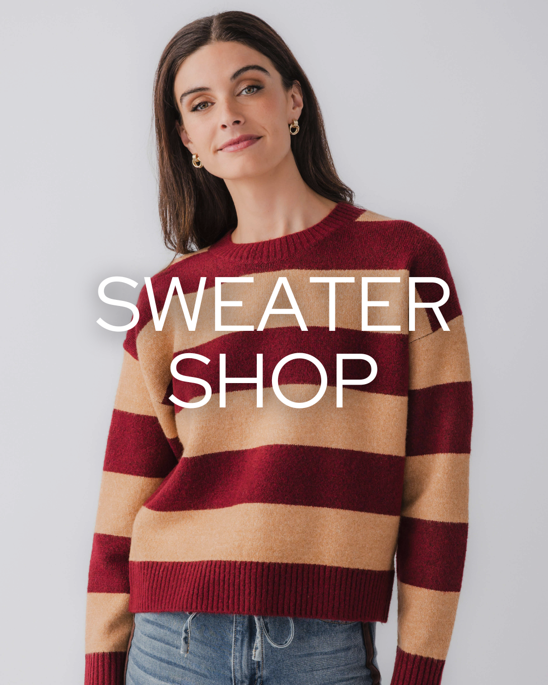 woman wearing jeans and striped sweater with words sweater shop