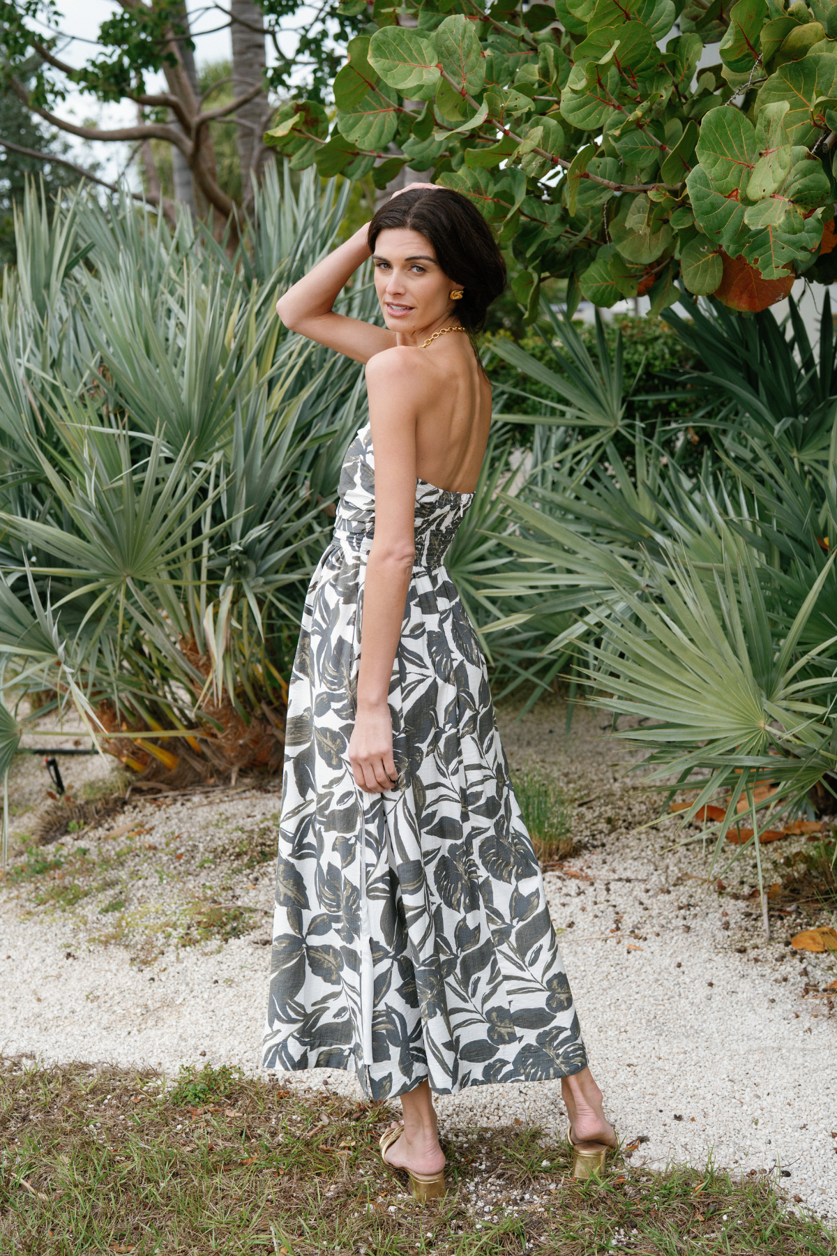 Dress Forum strapless black-and-white leaf print maxi dress with side slit, worn with tan sandals