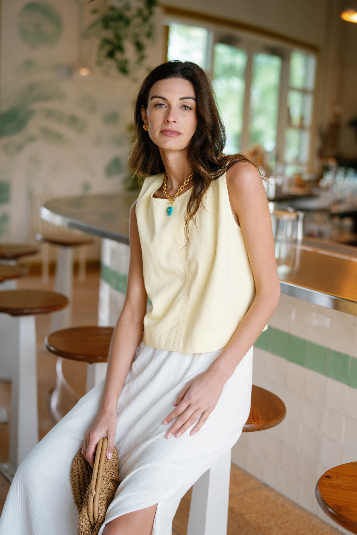 Cream sleeveless tank with round neckline and center seam detail