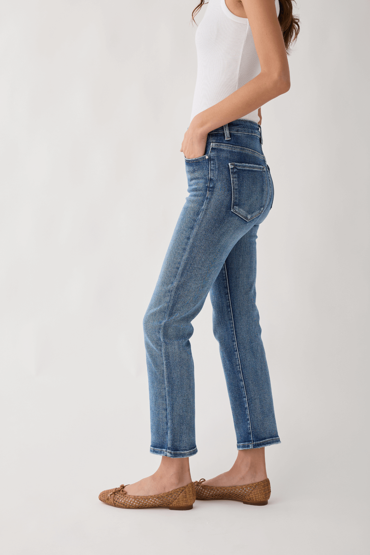 Medium wash straight-leg jeans with front pocket and belt loops, cropped hem.
