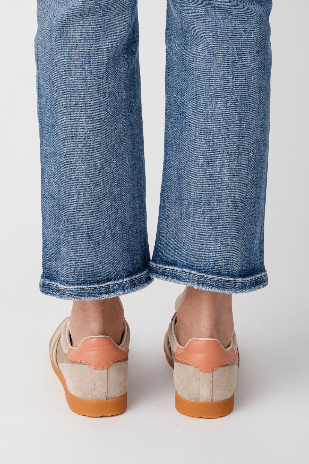 Back view of Gola low-top sneakers in bone with terracotta heel and rubber sole