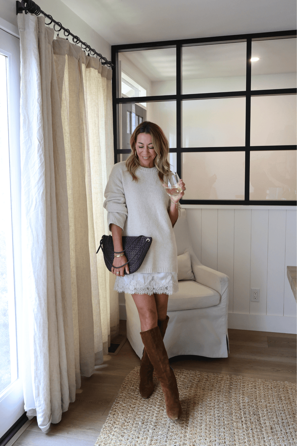 Light cream knit sweater dress with long sleeves and lace-trim hem