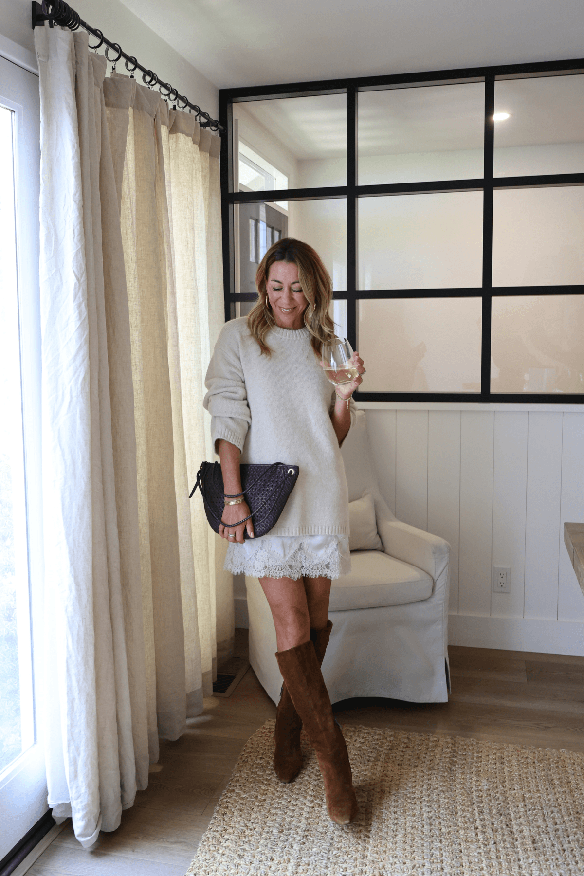 Light cream knit sweater dress with long sleeves and lace-trim hem