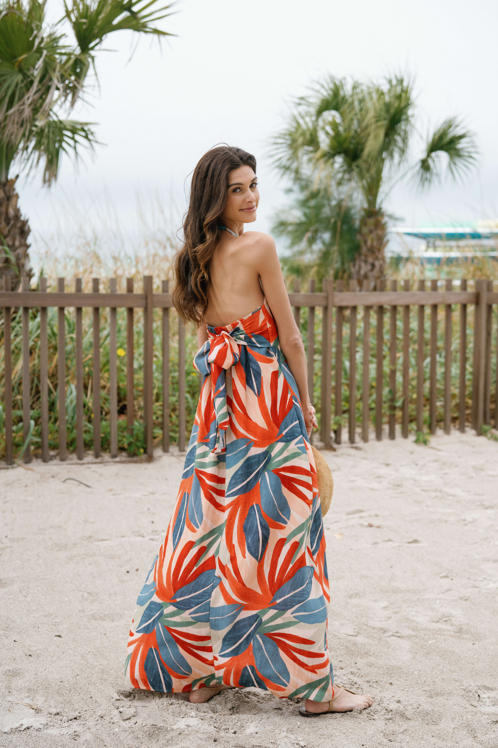 Strapless palm print maxi dress in orange, blue, and green with tiered skirt