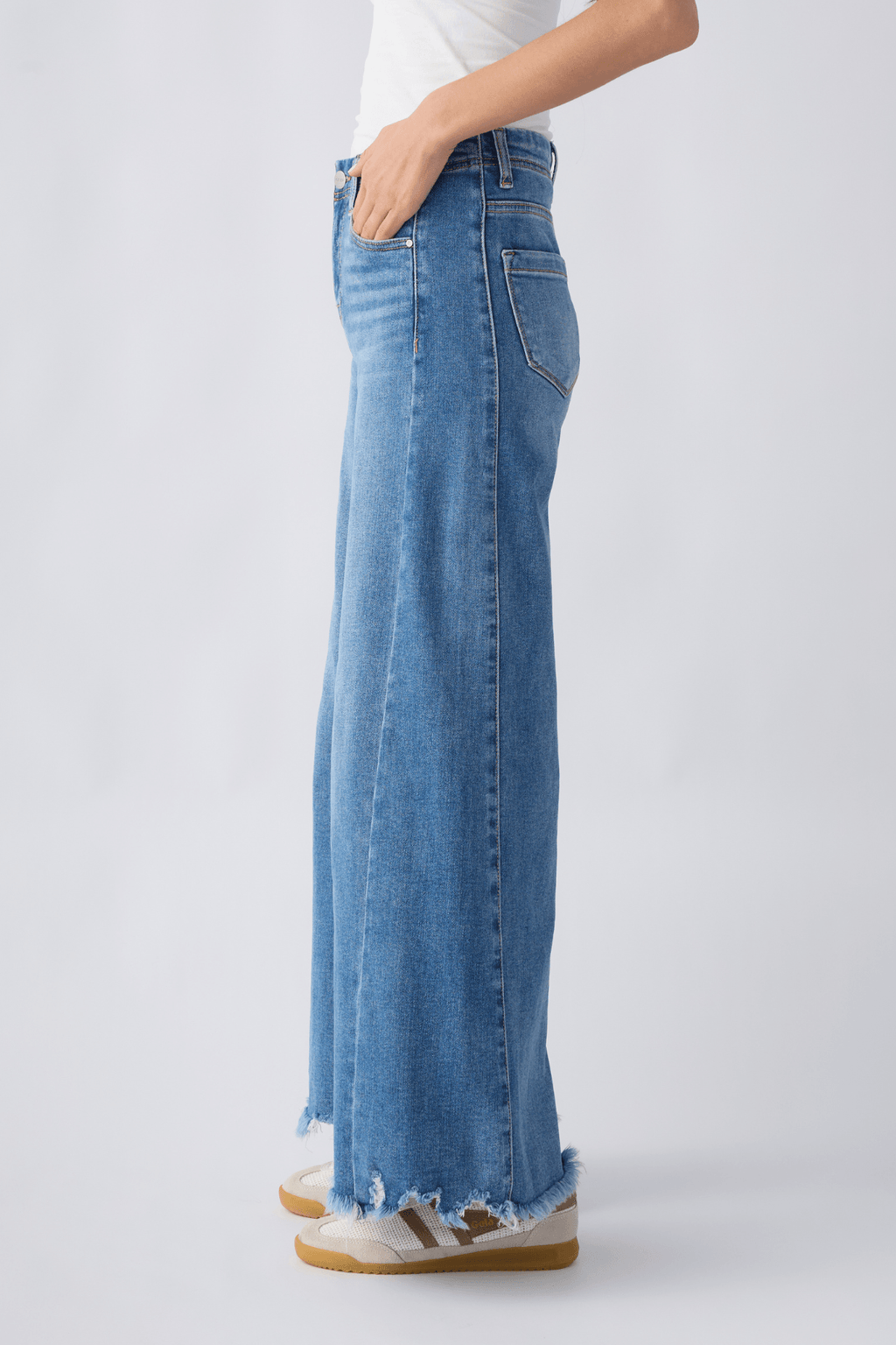 Side view of medium wash high-rise ultra wide leg jeans with belt loops and frayed hem.