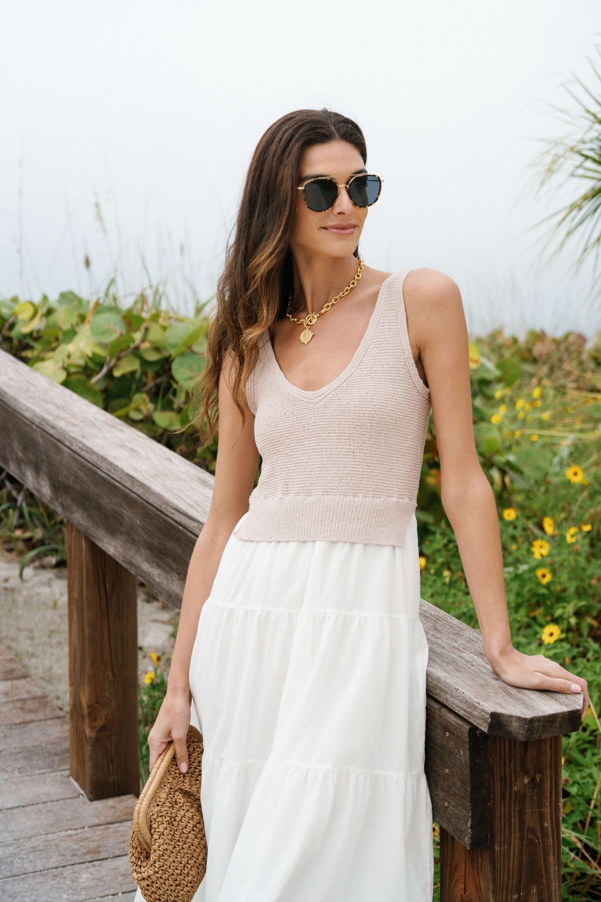 Front view of white maxi dress with scoop neck, textured bodice, and tiered skirt