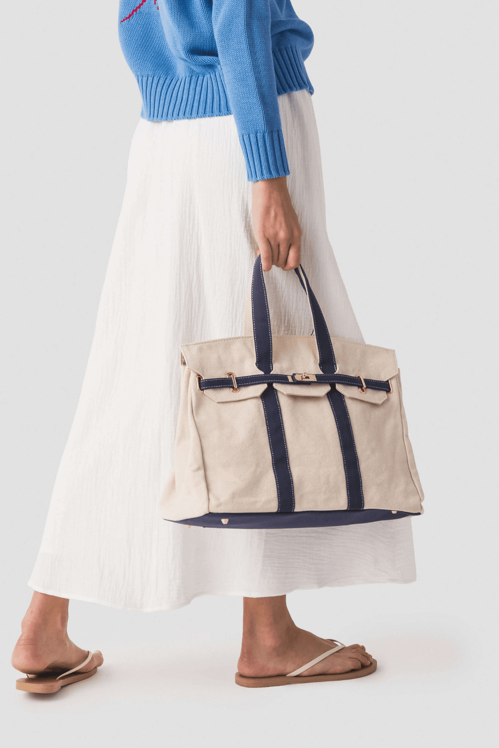 Cream canvas tote with navy center stripe and open-top handles