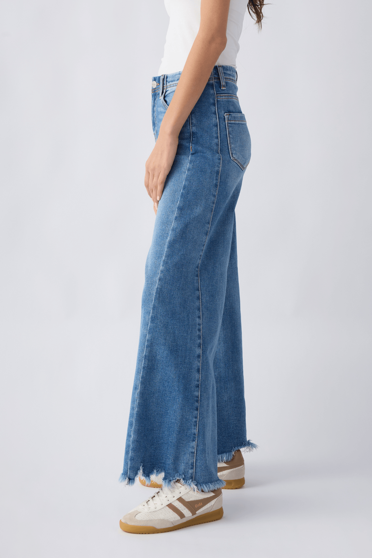 Medium wash high-rise ultra wide leg jeans, side seam stitching, frayed ankle hem.