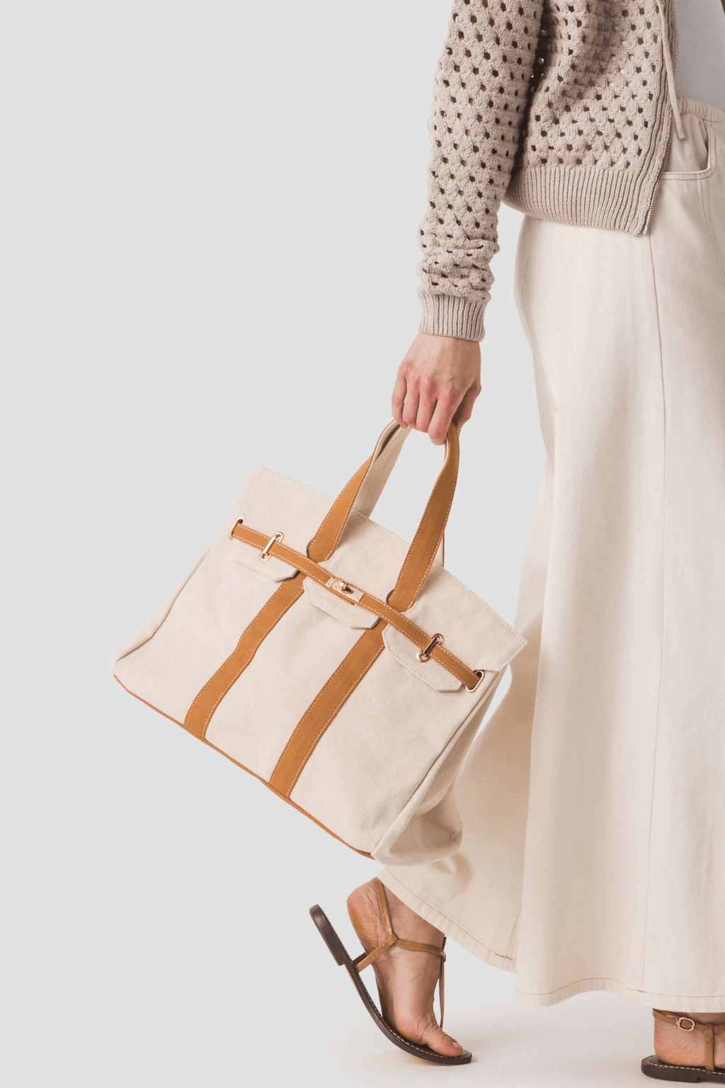 Tan canvas tote bag with tan leather-look trim and top handles