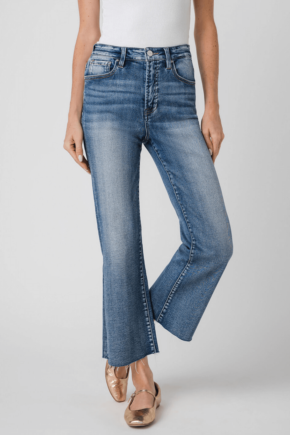 High-rise kick flare jeans in medium-wash blue, front view with classic five-pocket design.