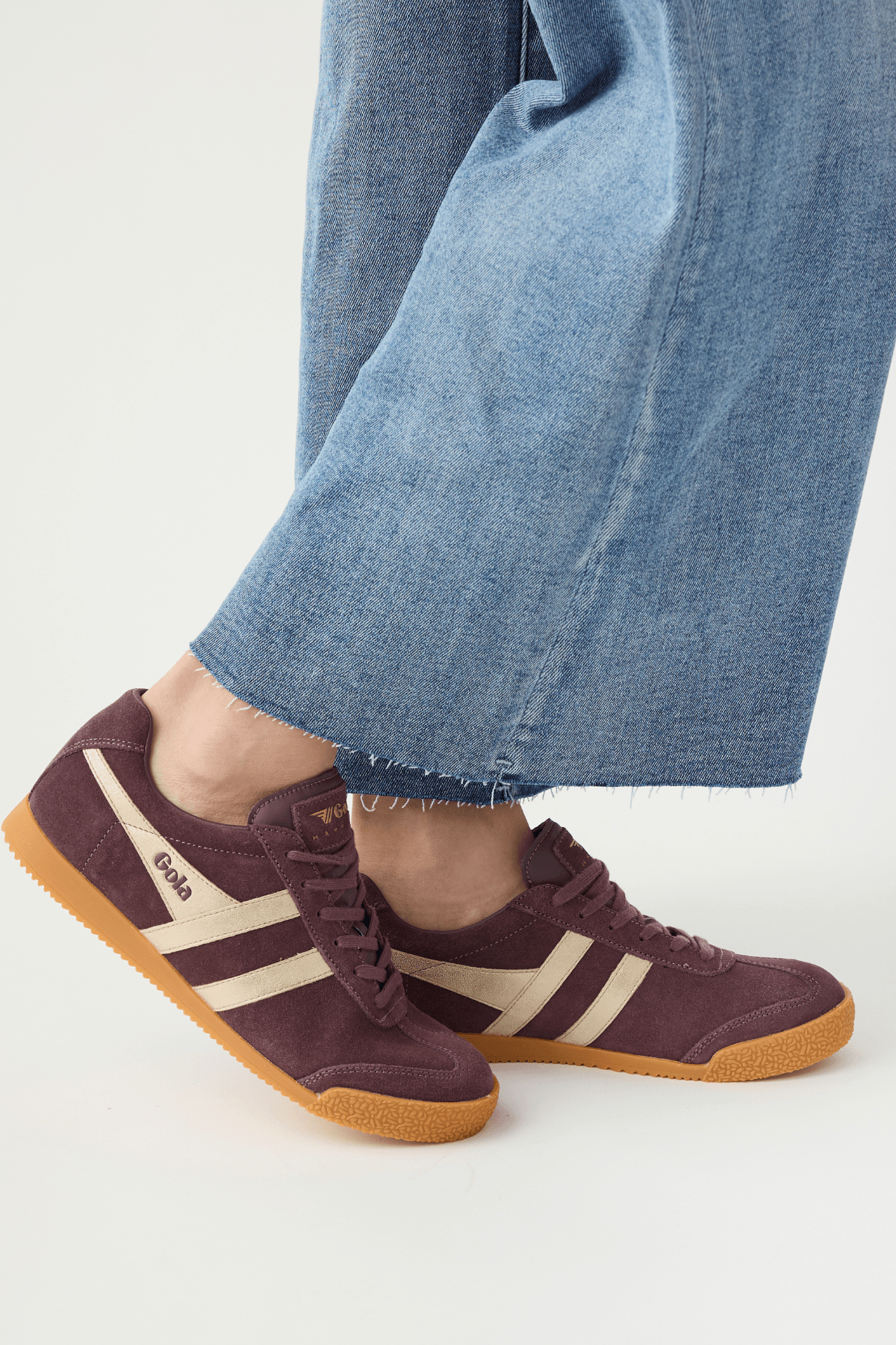 Cocoa brown suede lace-up sneakers with white side stripes and gum rubber sole