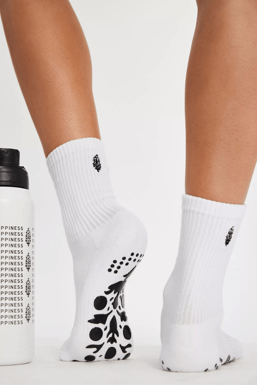 White ribbed pilates grip socks with black toe traction pattern