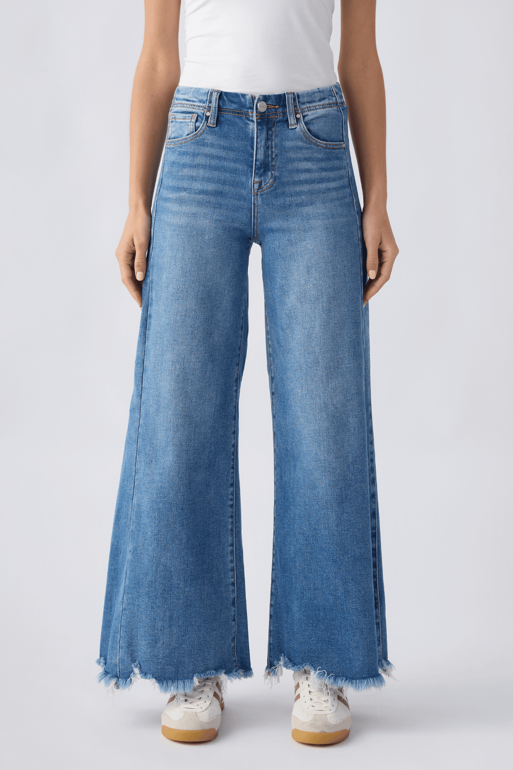 Front view of medium wash high-rise ultra wide leg jeans with button closure and belt loops.