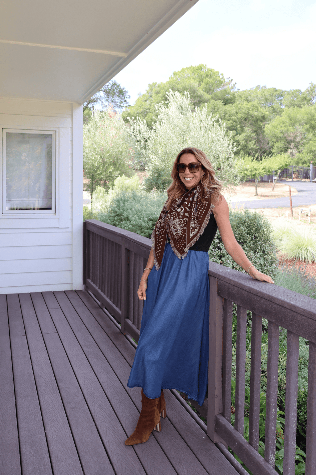 Dark navy bandana print scarf with tan and white paisley motifs