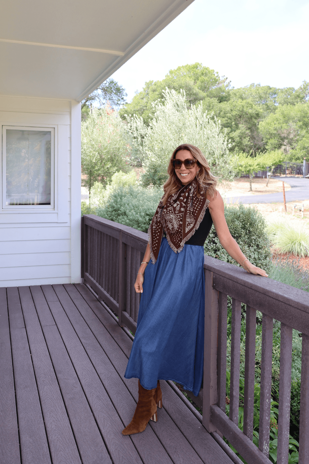 Dark navy bandana print scarf with tan and white paisley motifs