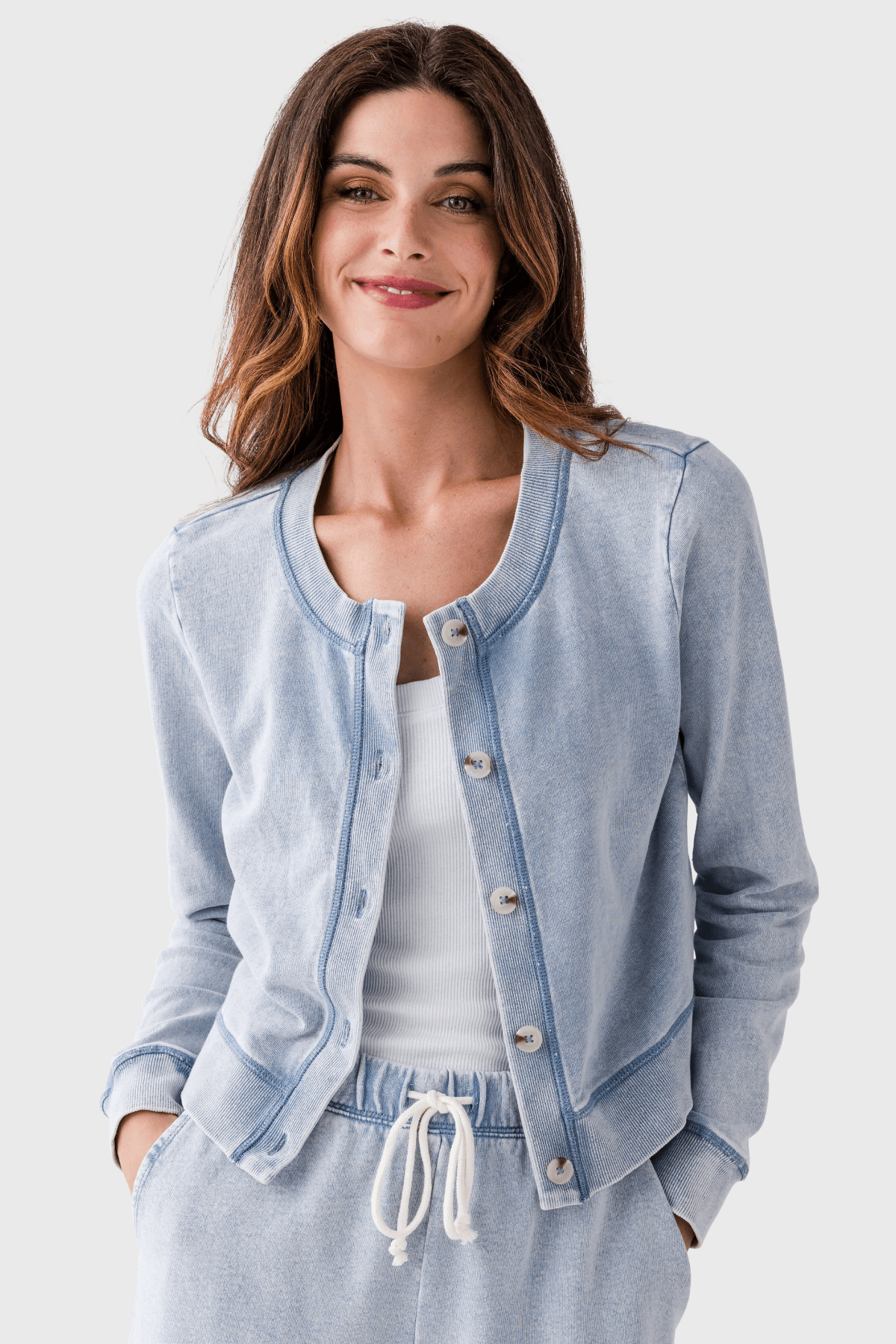 Light blue denim knit cardigan close-up with four buttons and V neckline