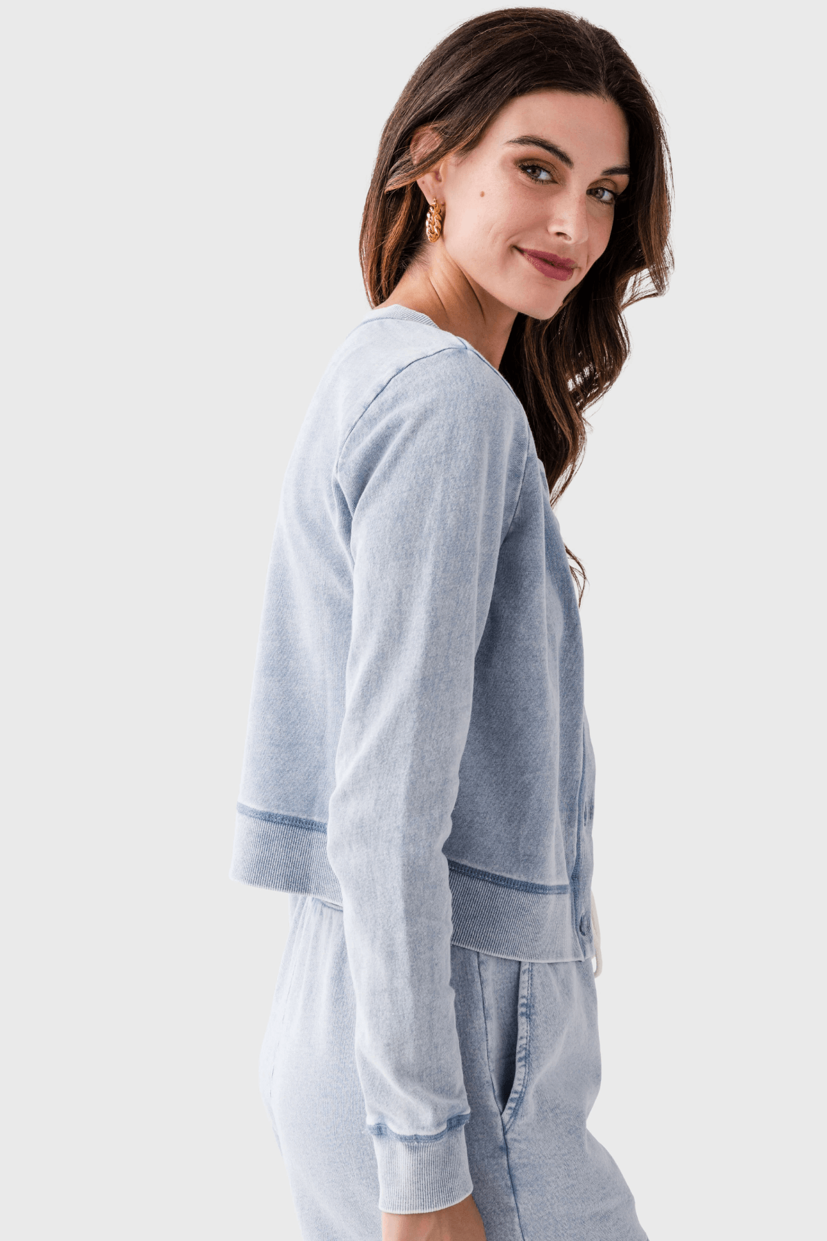 Light blue denim knit cardigan, side view, button front and long sleeves