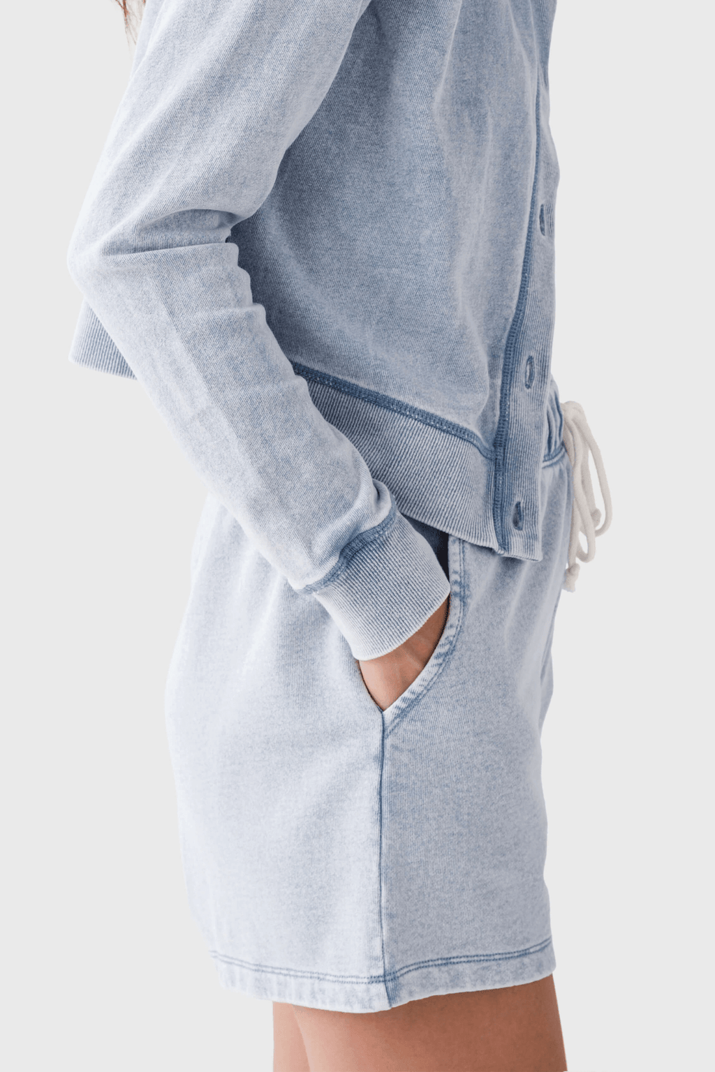Women’s light blue knit denim shorts with front pleats and side pockets