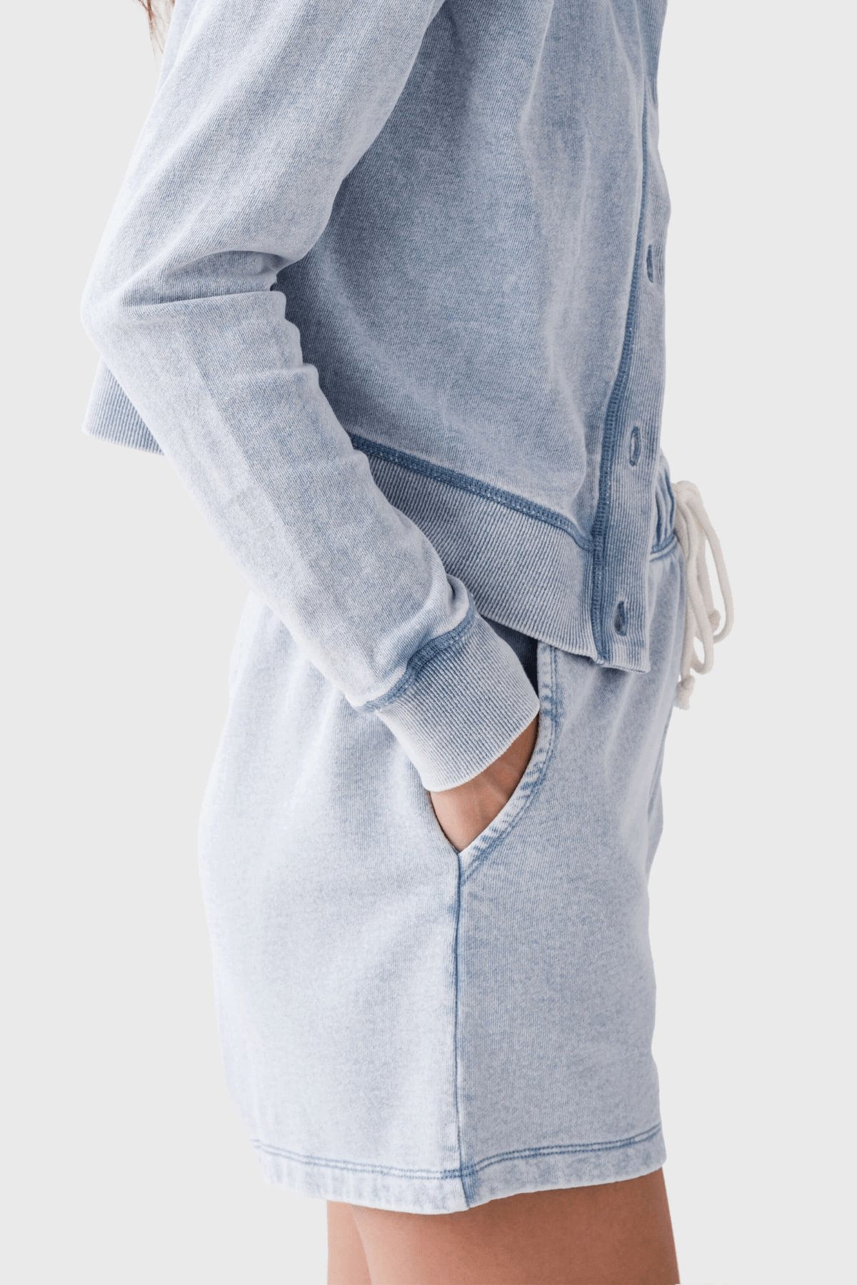 Women’s light blue knit denim shorts with front pleats and side pockets