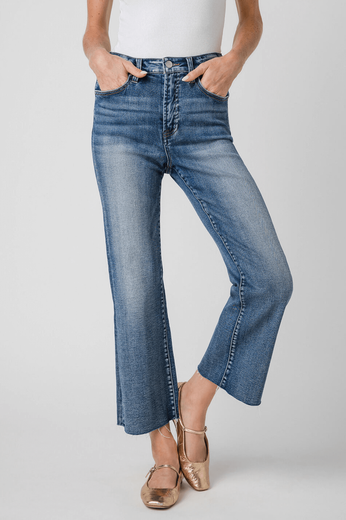 High-rise kick flare jeans in medium-wash blue, 3/4 front view with stitched back seams.