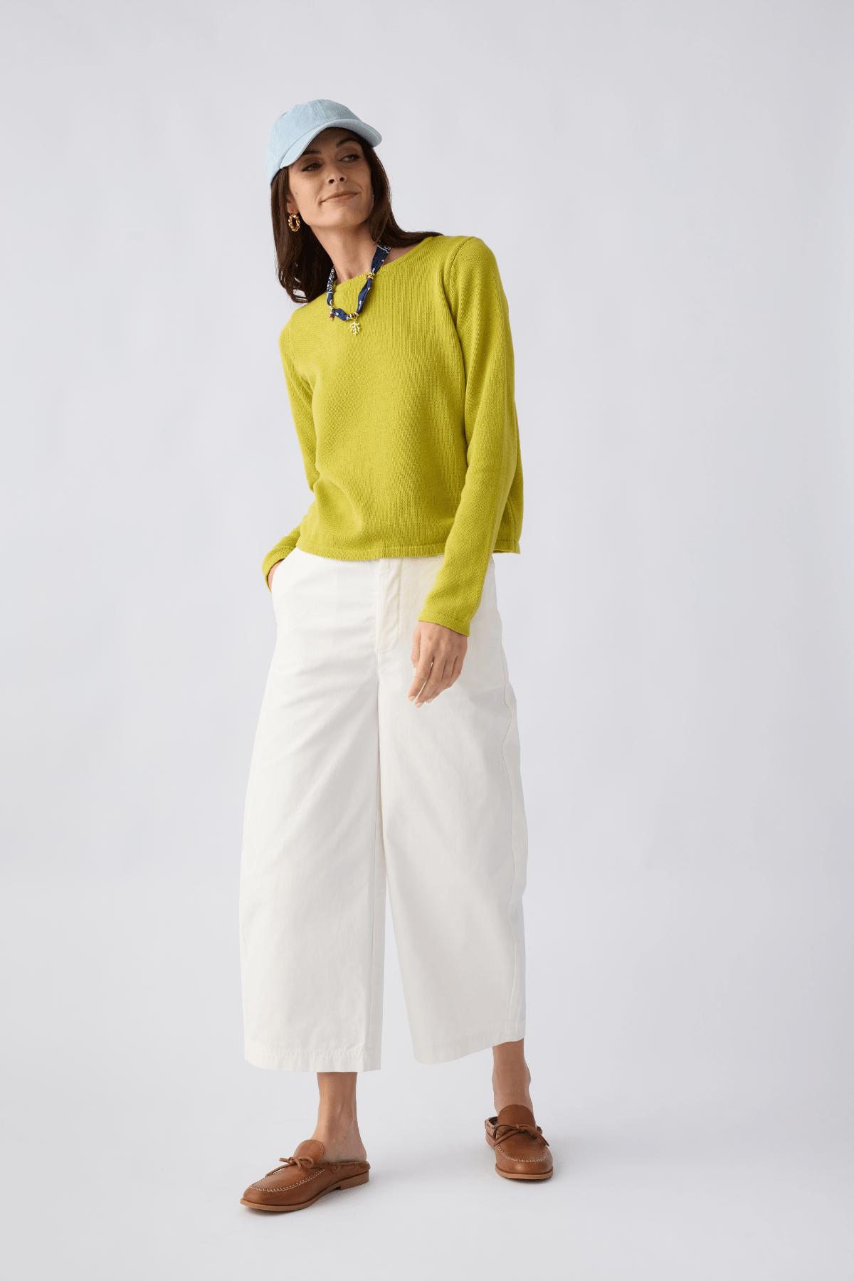 White/ivory chino pants with relaxed cropped legs, belt loops, and front button closure