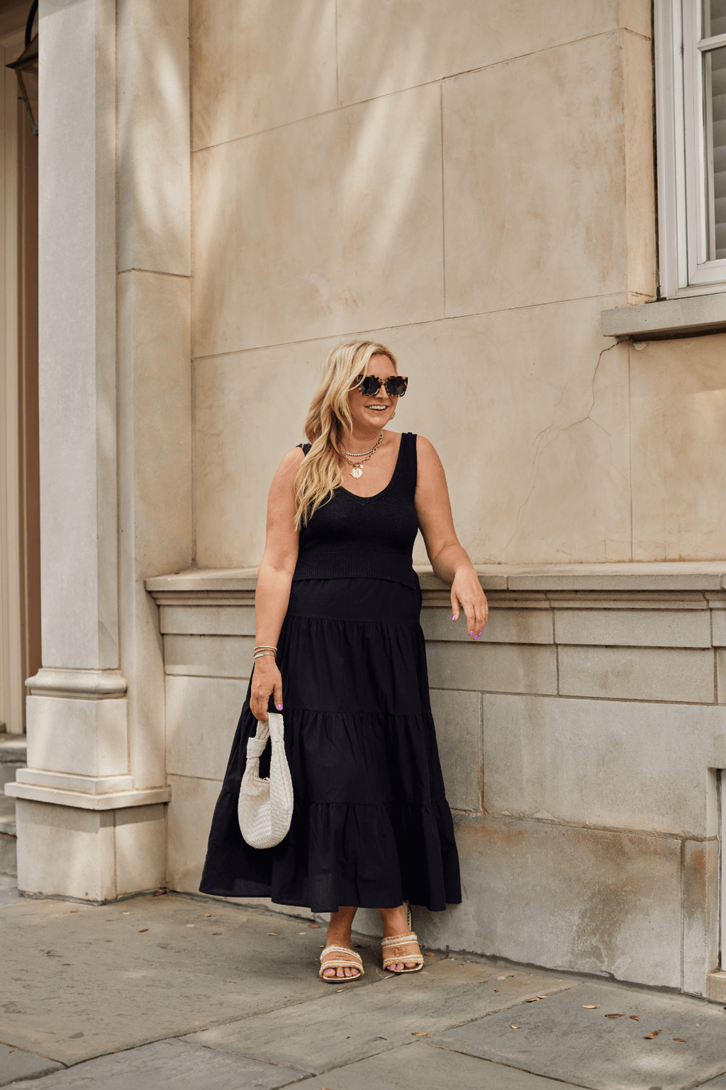 Black sleeveless maxi dress with scoop neck and tiered skirt
