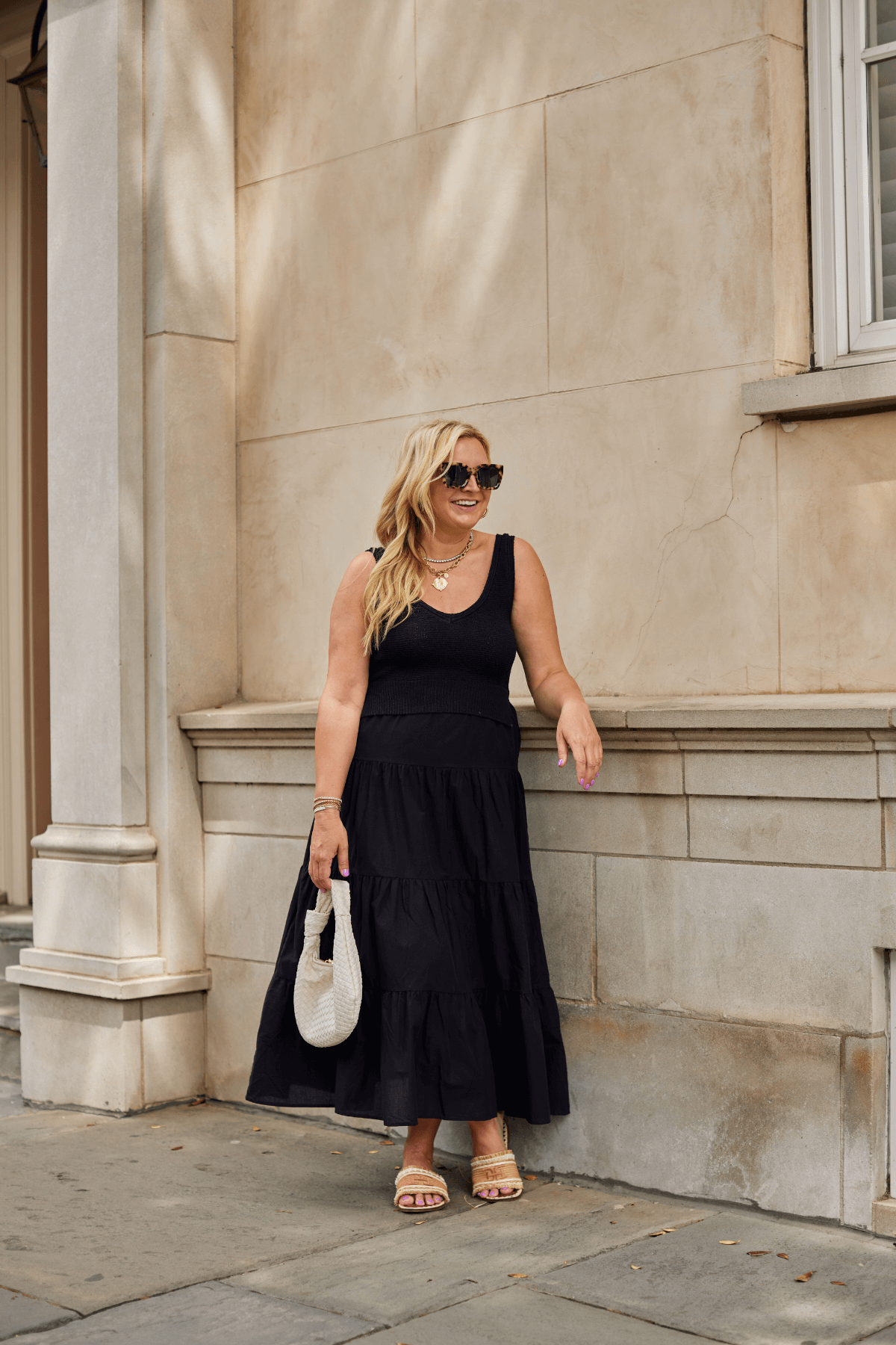Black sleeveless maxi dress with scoop neck and tiered skirt