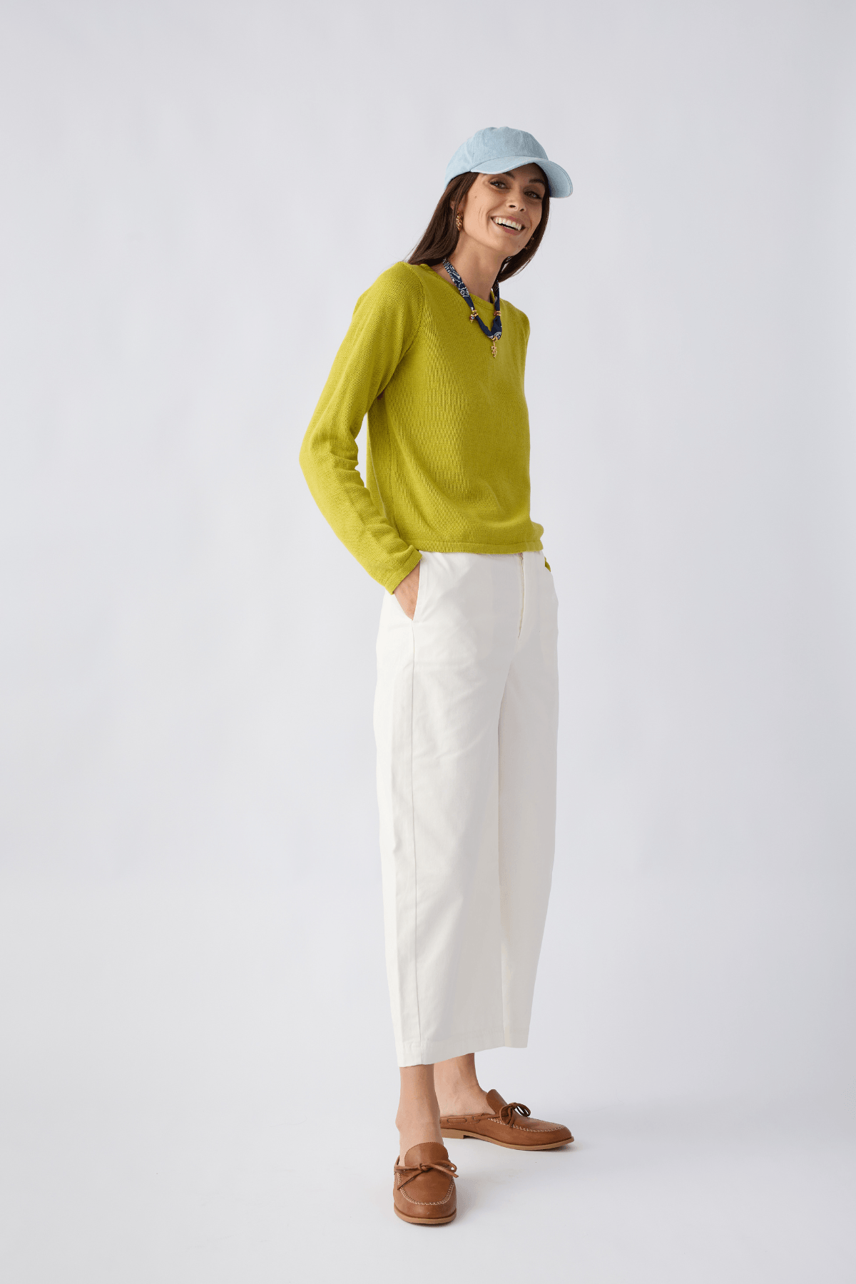 White/ivory chino pants with belt loops, slanted front pockets, and cropped straight fit