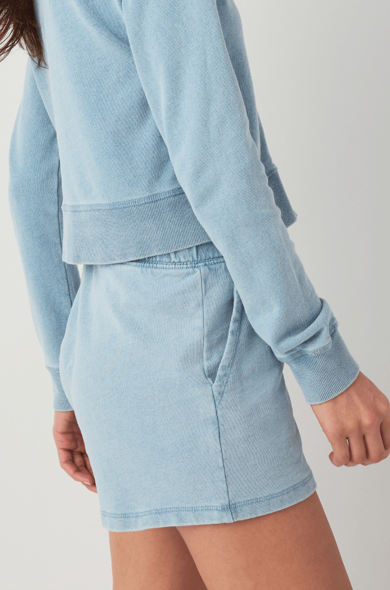 Women’s light blue knit denim shorts with soft knit hem and side pocket opening