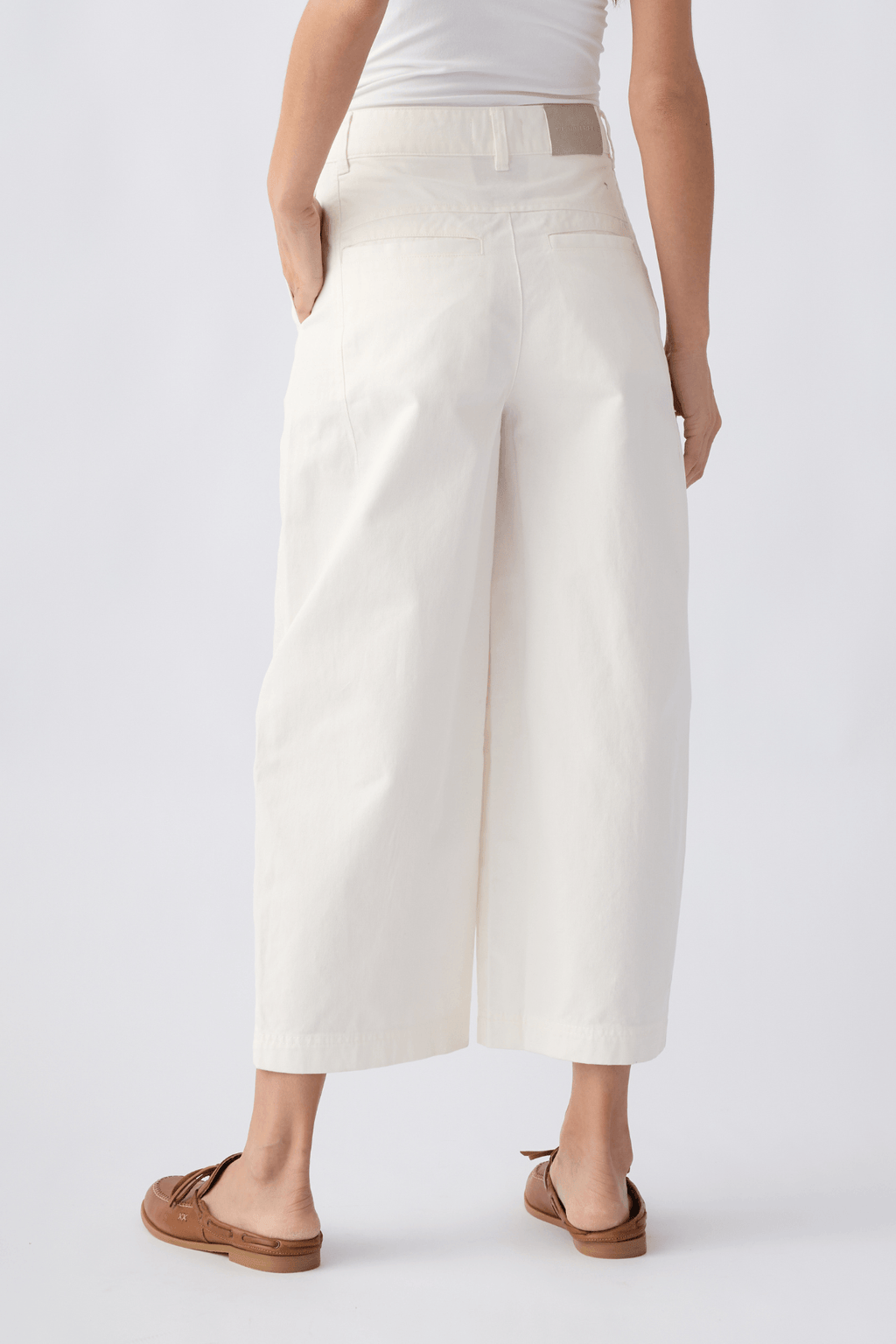 Ivory chino pants with belt loops, front pockets, and a cropped straight-leg design