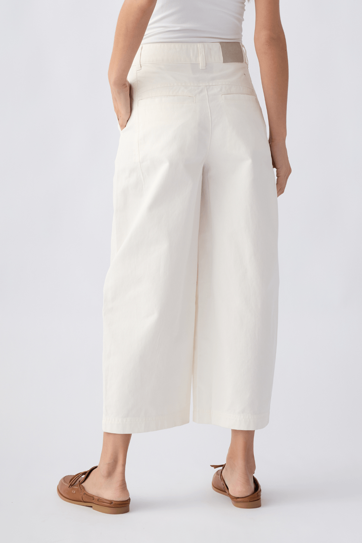 Ivory chino pants with belt loops, front pockets, and a cropped straight-leg design