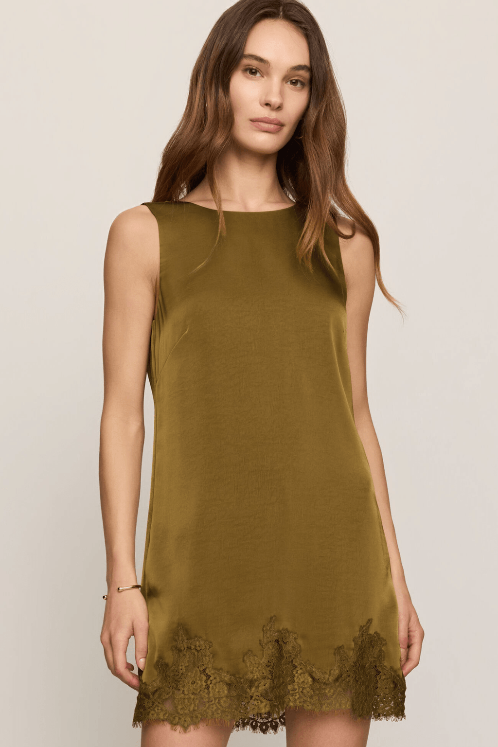 Sleeveless golden sage mini dress with scalloped lace border at hem
