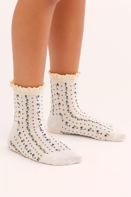 Ivory ankle socks with waffle-knit look and colorful sprinkle pattern, ruffled cuff