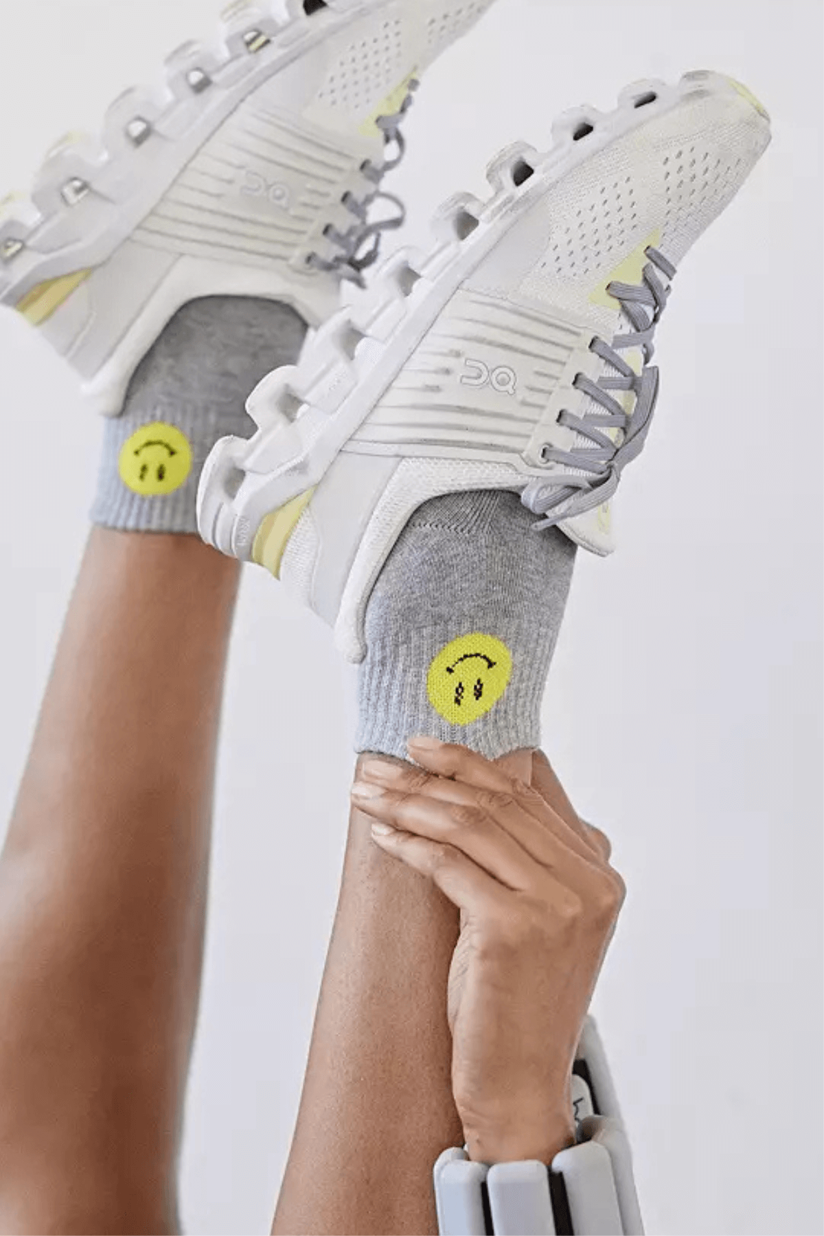 Gray ankle socks with yellow smiley face on cuff and ribbed knit design