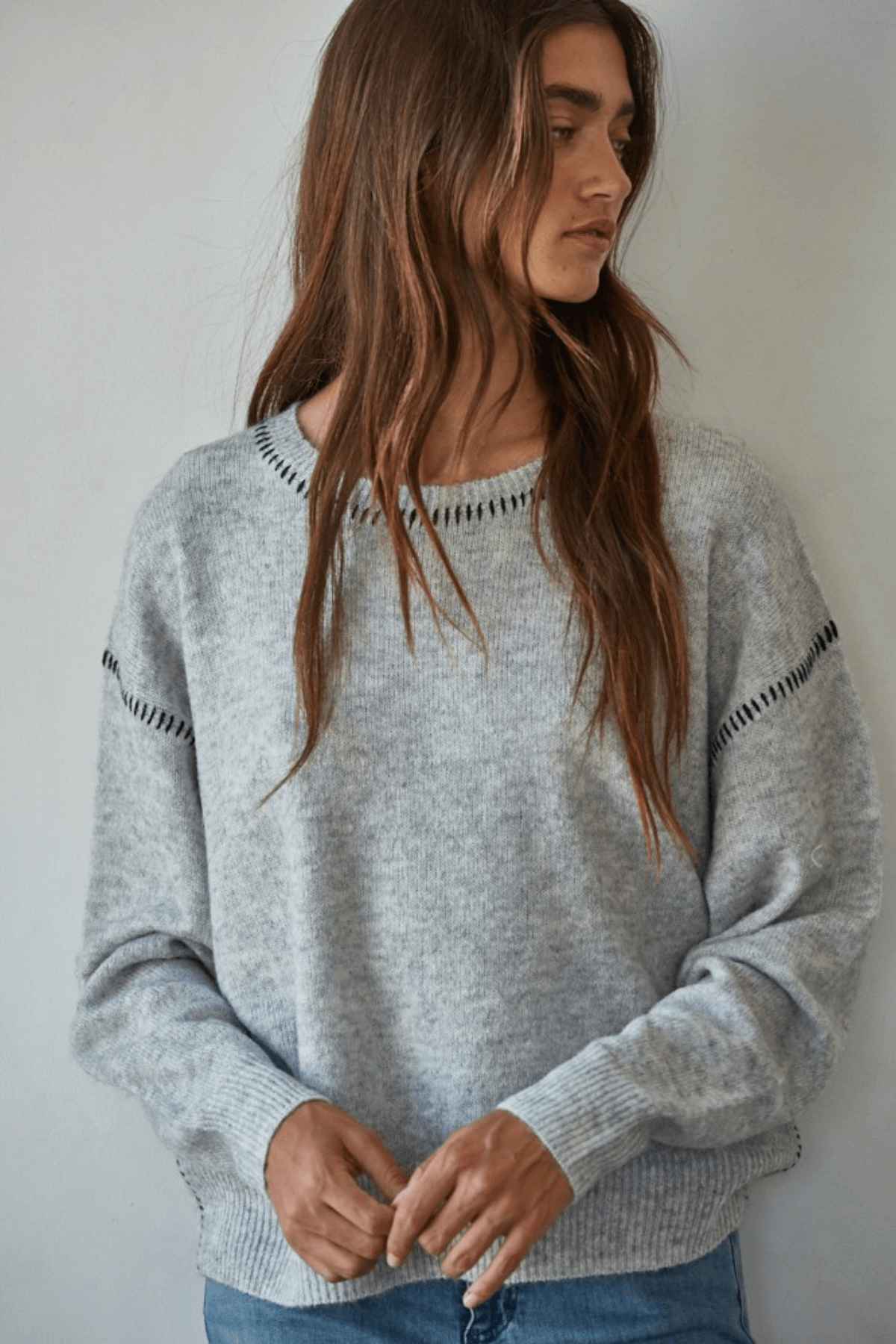Heather grey crewneck sweater with dark contrast stitch, ribbed cuffs and hem