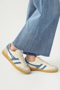 White leather low-top sneakers with blue stripes, lace-up front, and gum rubber sole