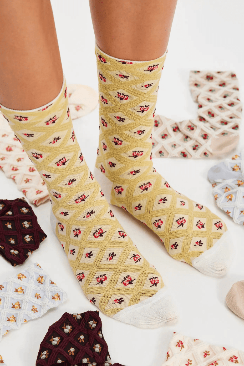 Cream trouser socks with small red patterned motifs, fabric ankle length