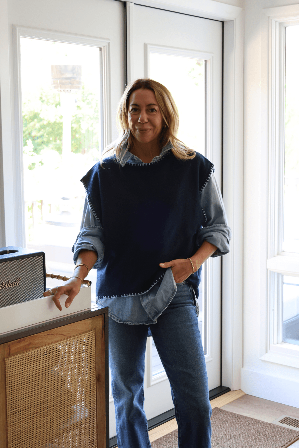 Blue denim button-front top with long sleeves, layered over dark inner