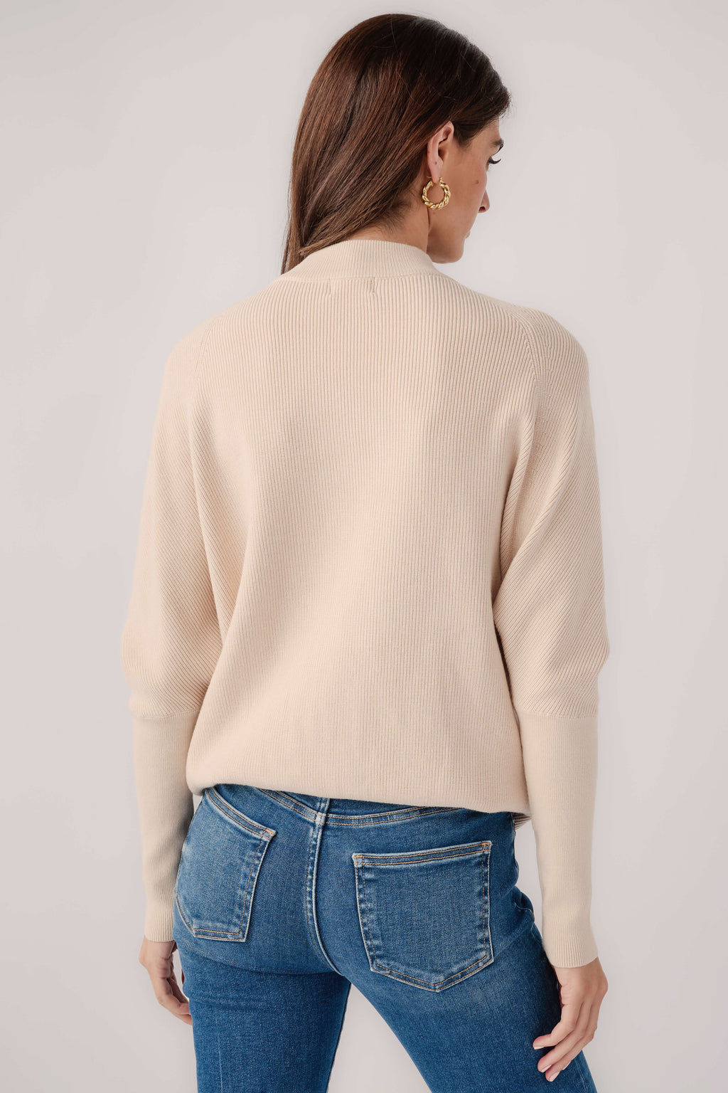 Cream slouch-neck dolman pullover sweater viewed from the back
