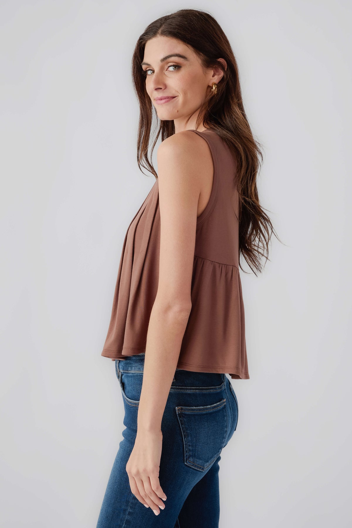 Chocolate sleeveless pleated top with round neck, side view