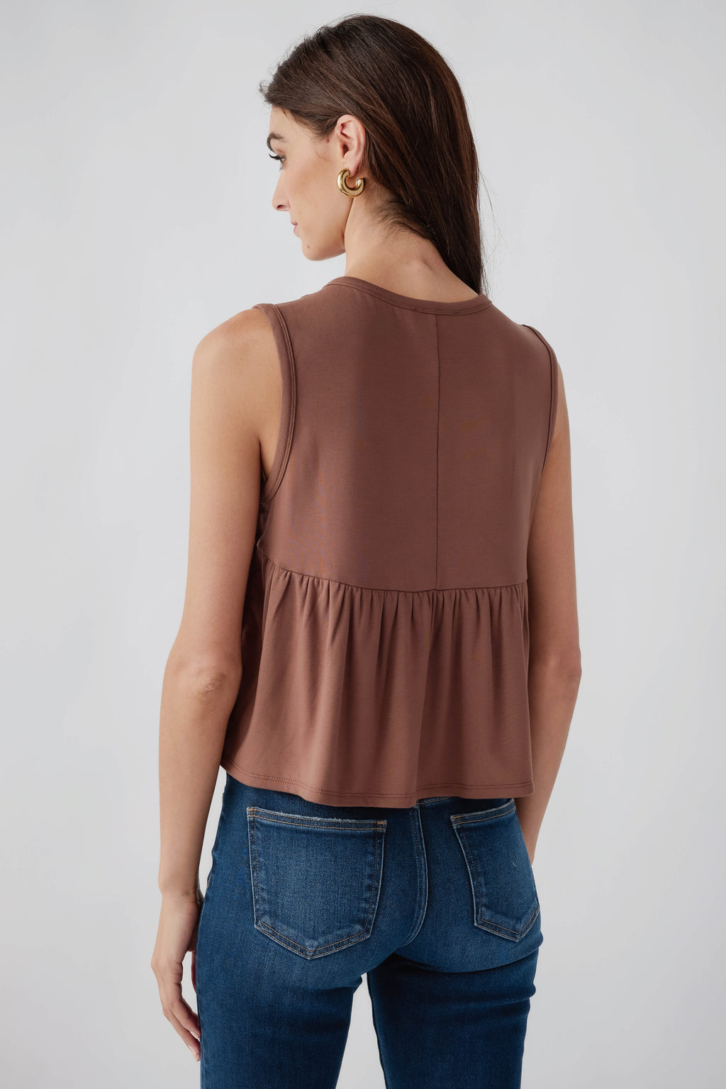 Chocolate sleeveless pleated top, back view with gathered hem
