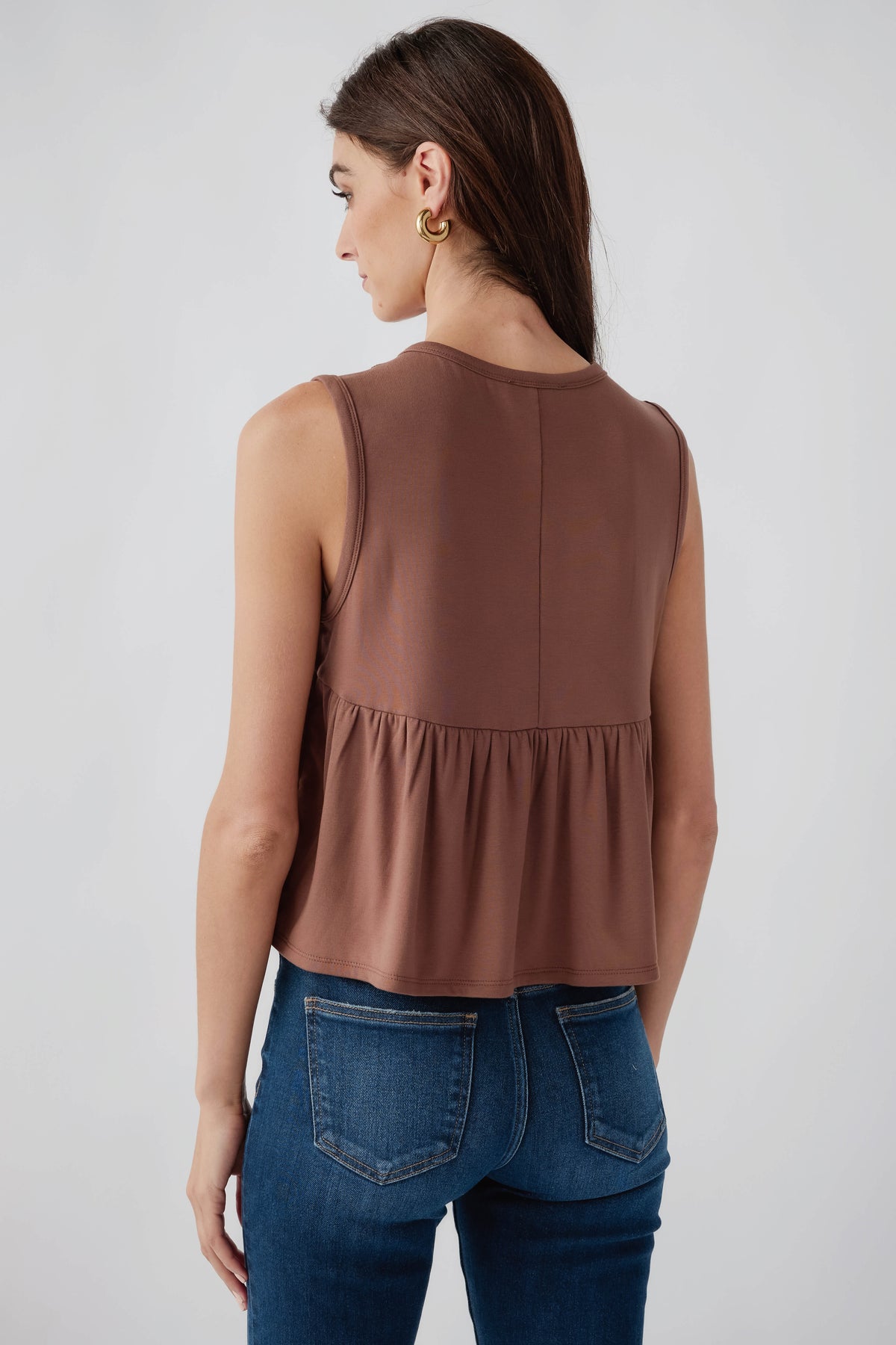 Chocolate sleeveless pleated top, back view with gathered hem