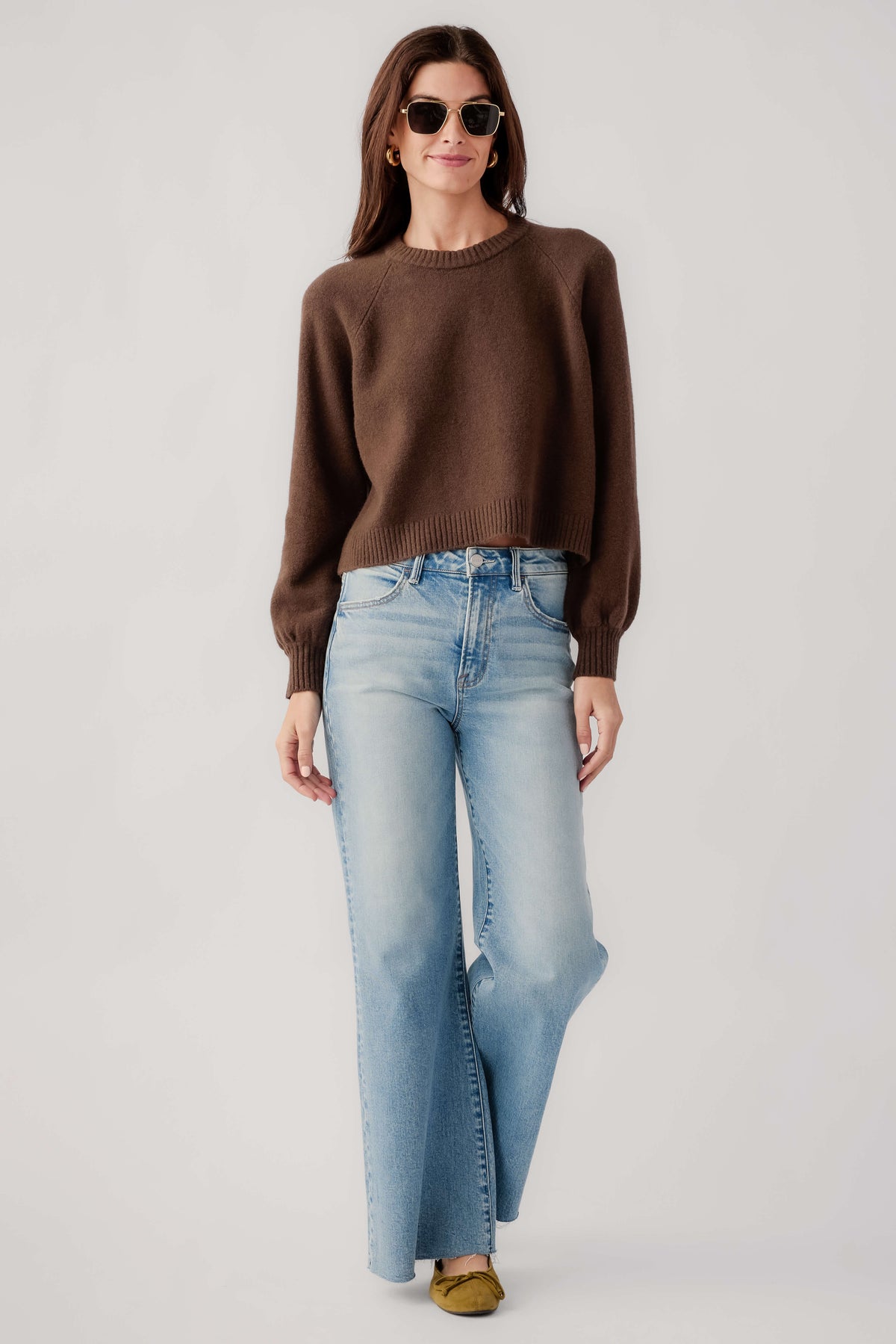 Dark brown crewneck knit sweater with ribbed cuffs and hem, front view