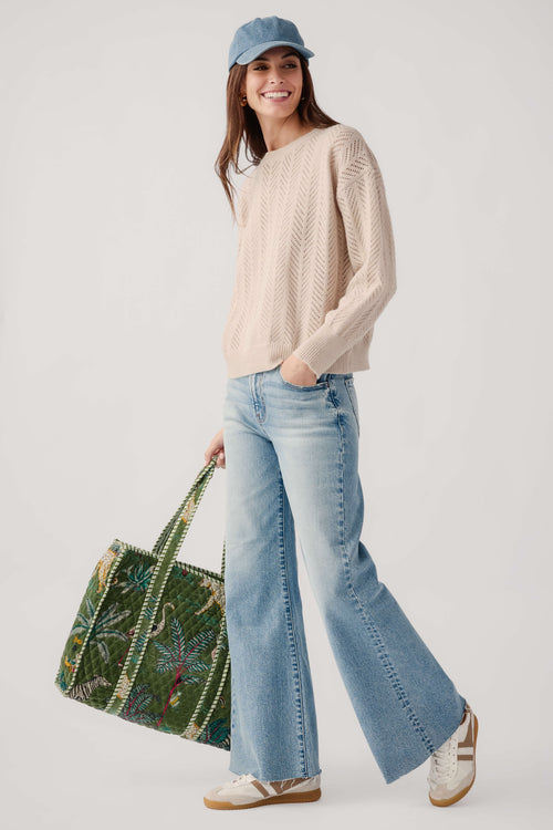 Light blue high-rise wide-leg jeans with wide flare legs on model