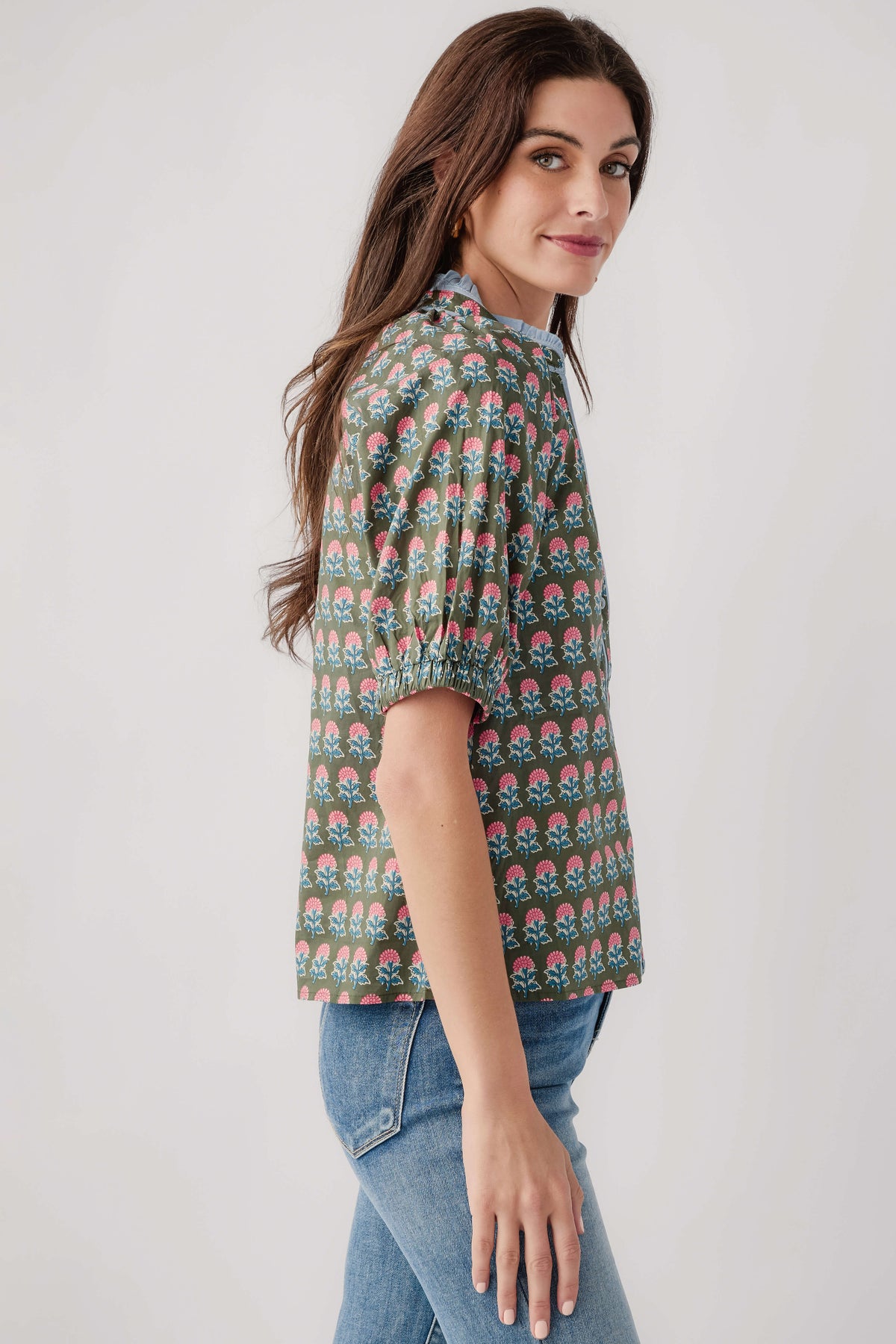 Green block-print top, short puff sleeves and rounded hem; side profile