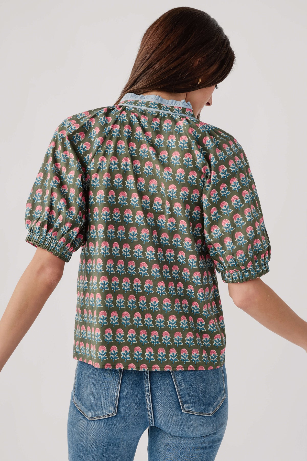 Back of green block-print top with puff sleeves and gathered yoke