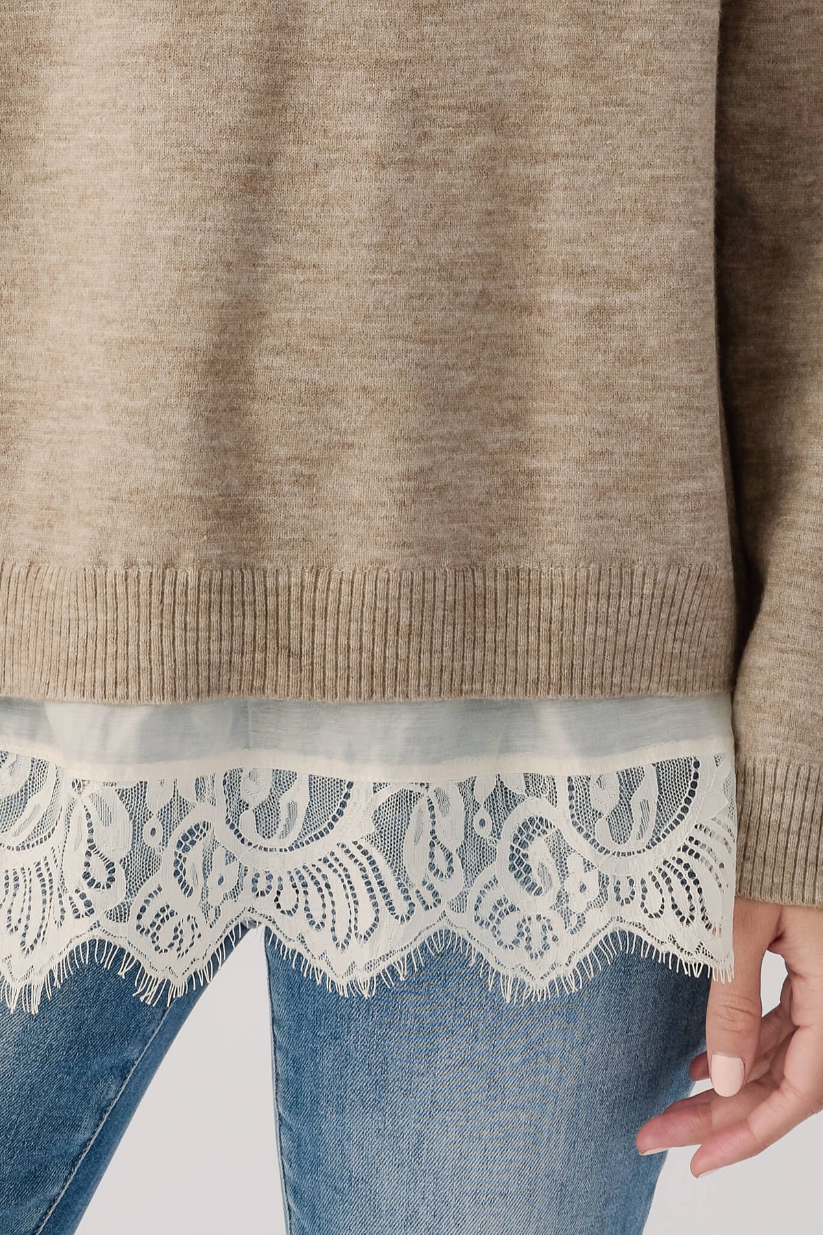 Heather mocha cream sweater hem with ribbed band and light lace trim over denim