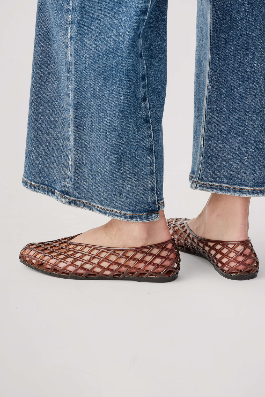 Brown lattice jelly ballet flats, side view with rounded toe and flat sole