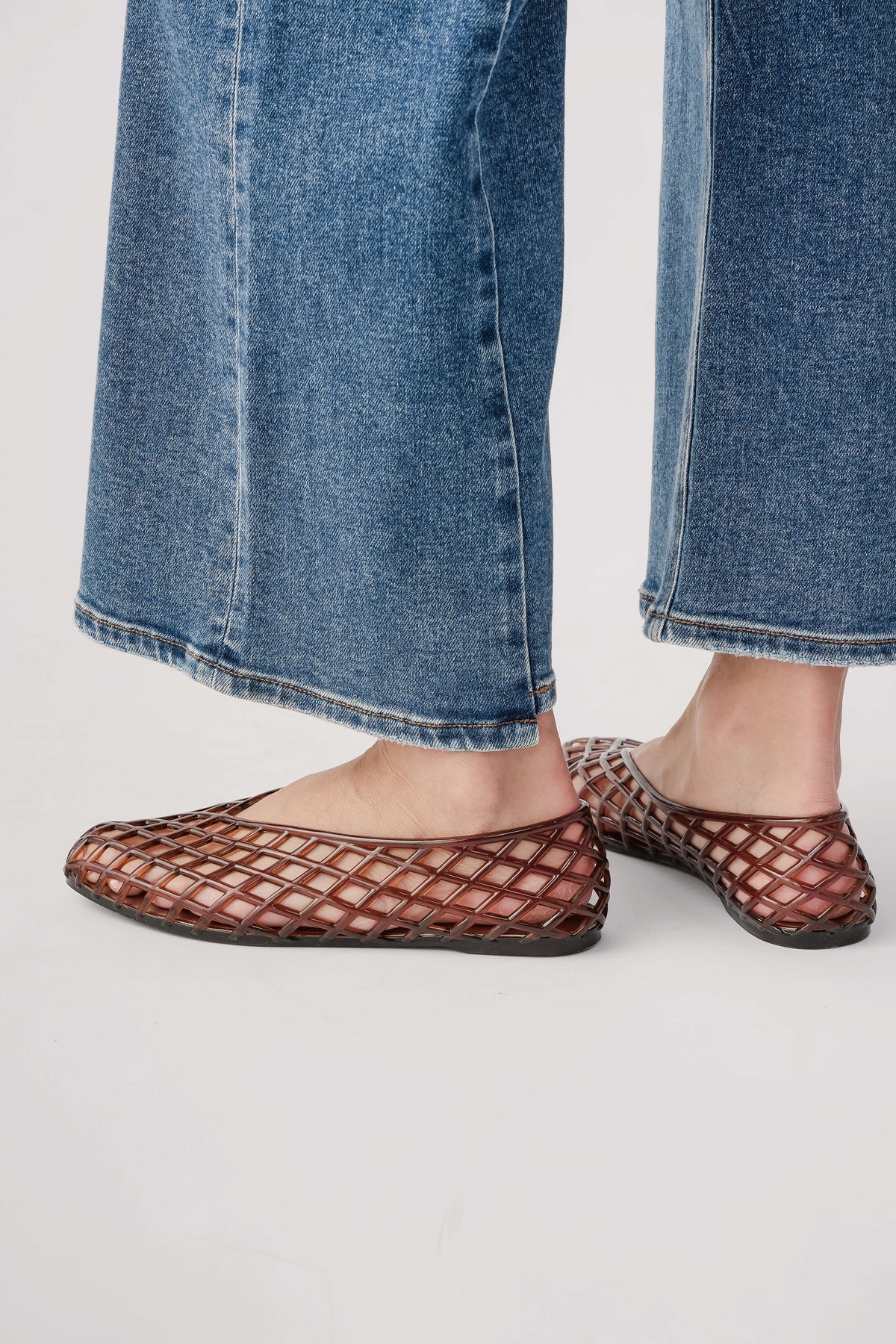 Brown lattice jelly ballet flats, side view with rounded toe and flat sole