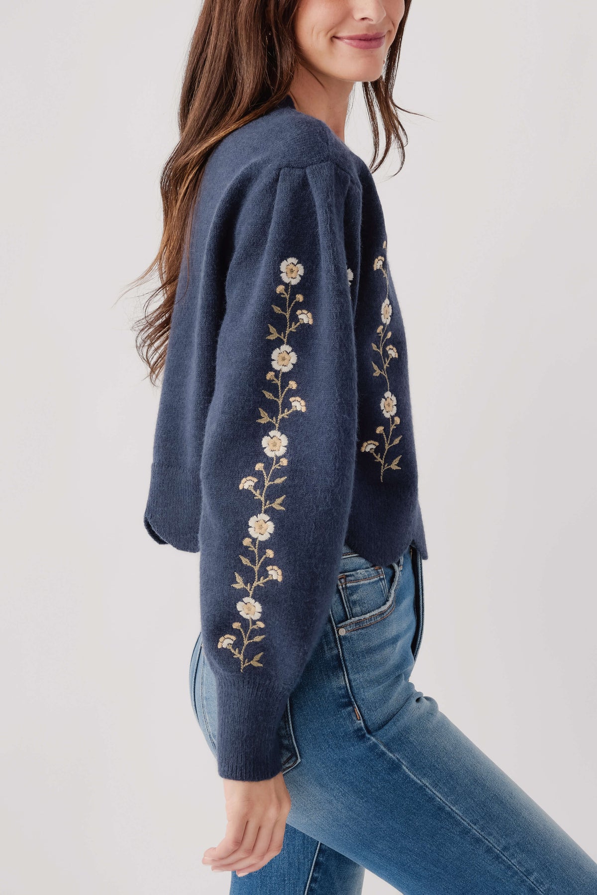Navy long-sleeve sweater with floral vine embroidery on sleeves